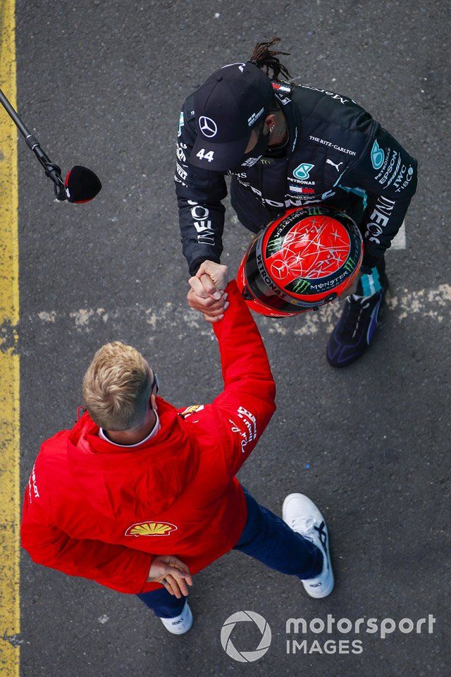 Mick Schumacher, Alfa Romeo Racing, presents race winner Lewis Hamilton, Mercedes-AMG F1, with the Mercedes helmet of his father, Michael Schumacher, from 2012