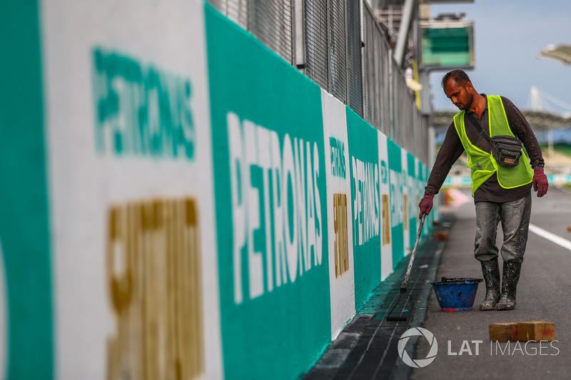 Track worker paints Petronas branding