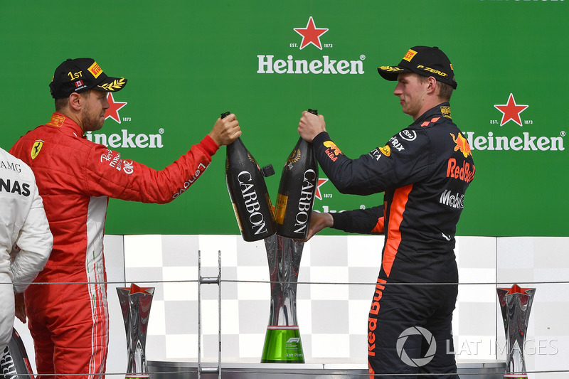 Sebastian Vettel, Ferrari and Max Verstappen, Red Bull Racing celebrate on the podium with the champ