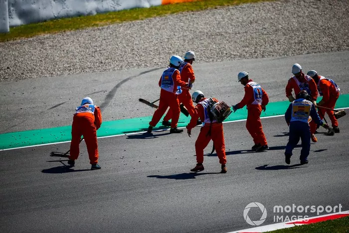 Los oficiales limpian la pista después del accidente de Lando Norris, McLaren MCL34 y Lance Stroll, Racing Point RP19 