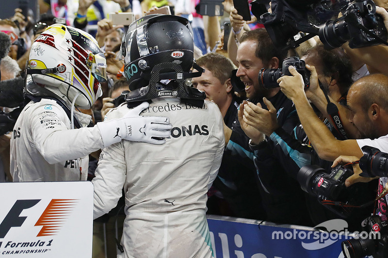 Nico Rosberg, Mercedes AMG F1, celebrates in Parc Ferme after finishing in second position and winning the championship with team mate Lewis Hamilton, Mercedes AMG F1