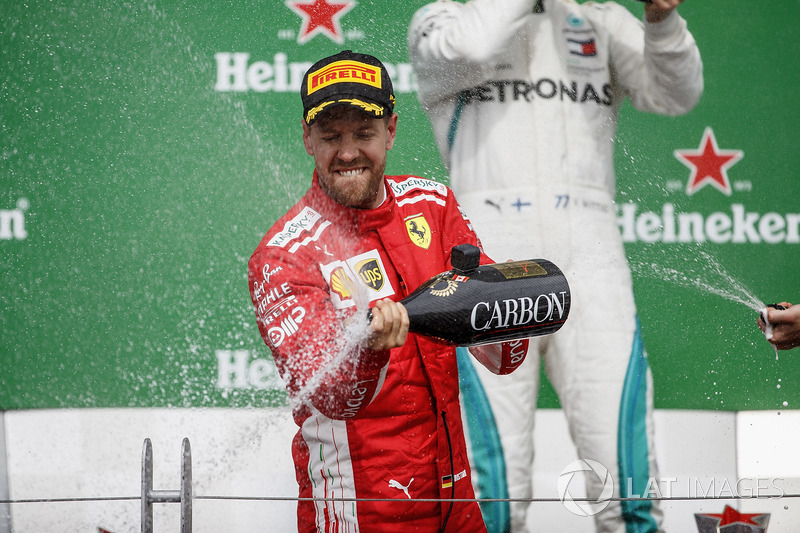 Sebastian Vettel, Ferrari, 1st position, sprays the victory Champagne