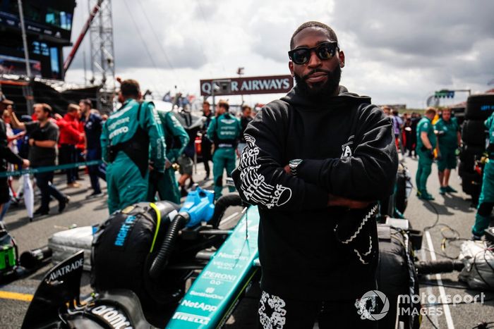 El rapero Tinie Tempah en la parrilla con el coche de Fernando Alonso, el Aston Martin AMR23