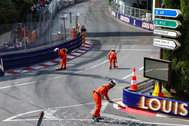 Marshals clear the track under the red flag.