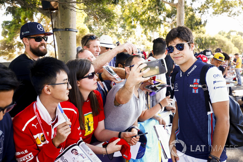 Lance Stroll, Williams Racing, takes a selfie with a fan