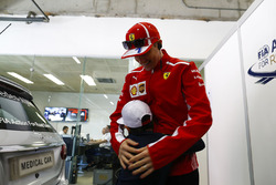 Kimi Raikkonen, Ferrari, meets a young fan