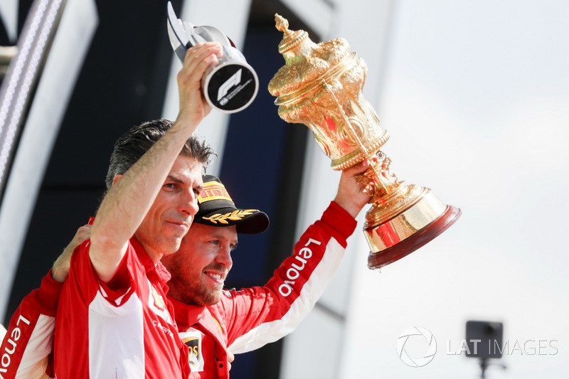 Sebastian Vettel, Ferrari, on the podium with the Ferrari Constructors trophy delegate