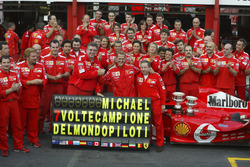 Michael Schumacher, Ferrari F2004 celebrates with the Ferrari team after winning his 7th world champ