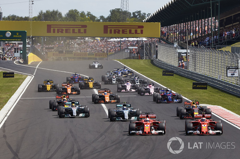 Sebastian Vettel, Ferrari SF70H, Kimi Raikkonen, Ferrari SF70H, lead the field away at the start