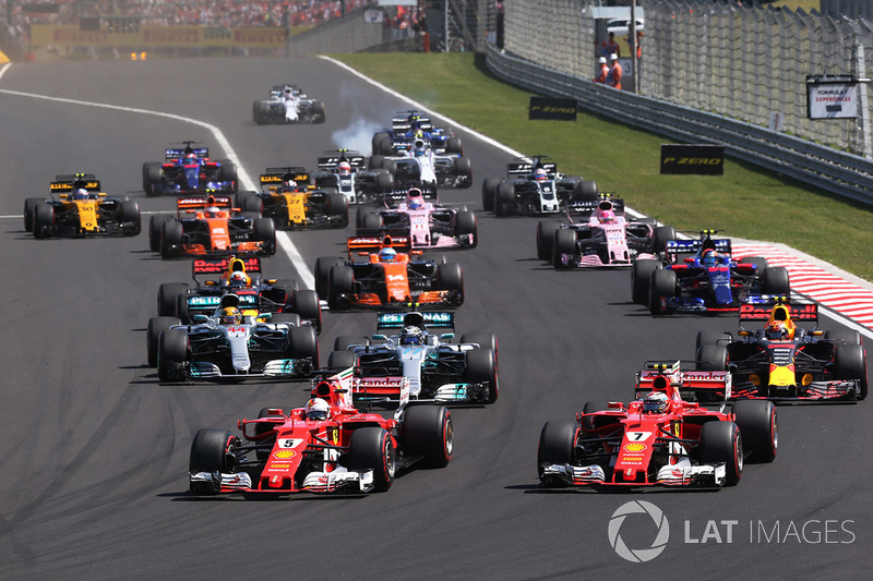 Sebastian Vettel, Ferrari SF70H, leads, Kimi Raikkonen, Ferrari SF70H at the start of the race