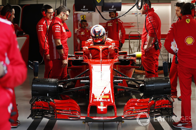 Kimi Raikkonen, Ferrari, enters his cockpit