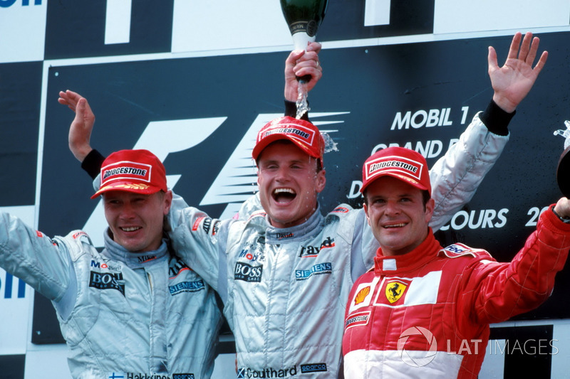 Podium: second place Mika Hakkinen, McLaren, race winner David Coulthard, McLaren, third place Rubens Barrichello, Ferrari