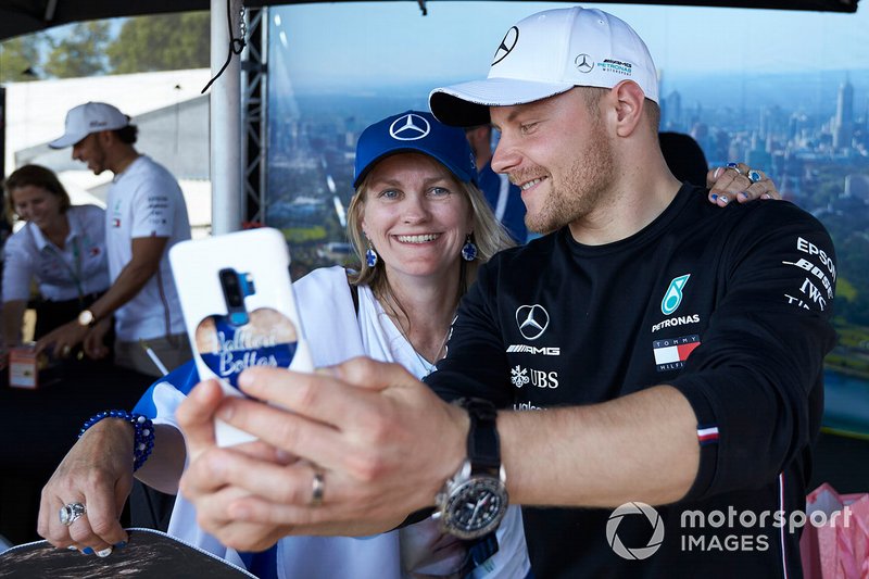 Valtteri Bottas, Mercedes AMG F1, takes a selfie with a fan