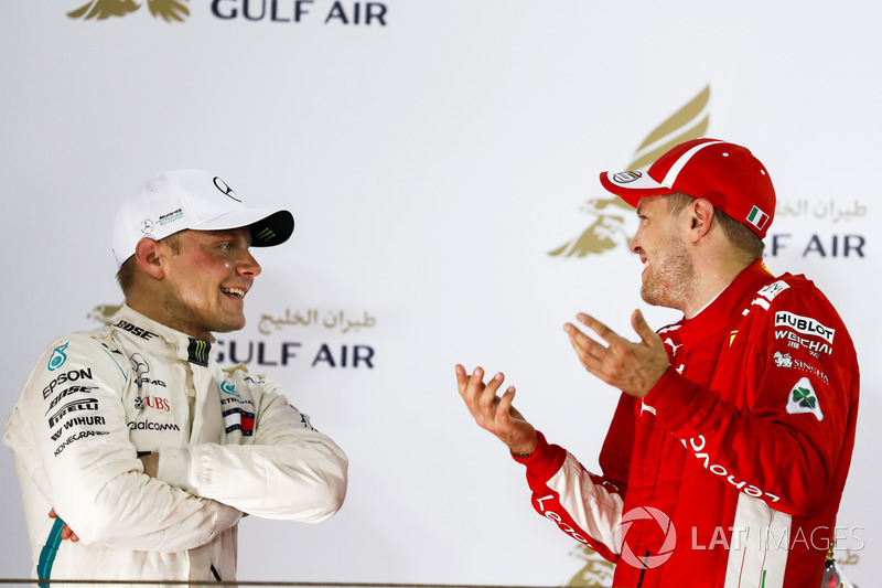 Valtteri Bottas, Mercedes AMG F1, 2nd position, and Sebastian Vettel, Ferrari, 1st position, talk on the podium