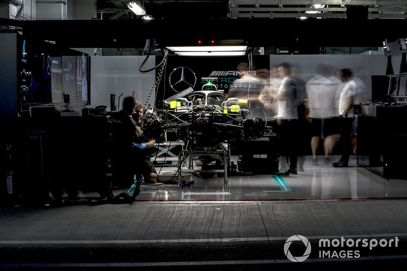 Engineers work on the car of Lewis Hamilton, Mercedes AMG F1 W09 EQ Power+, in the garage