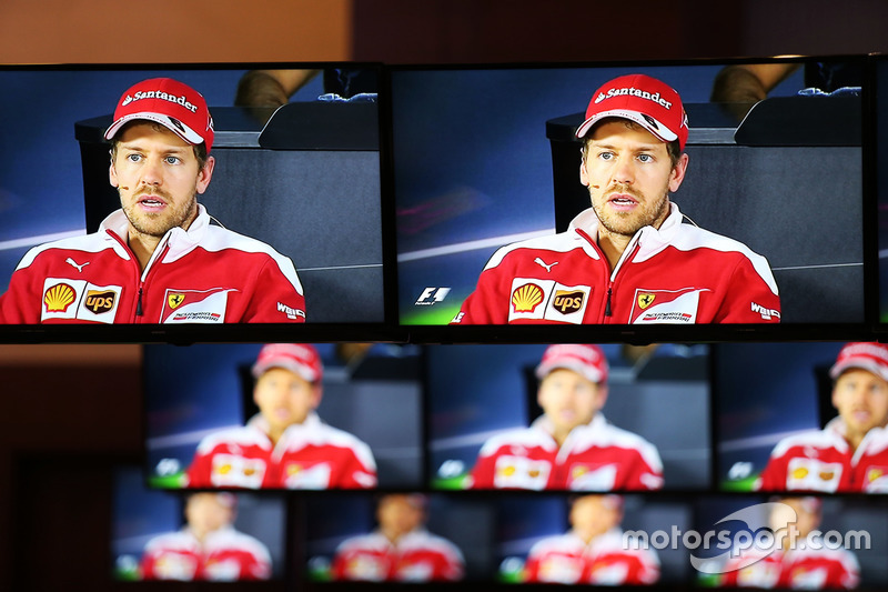 Sebastian Vettel, Ferrari in the FIA Press Conference on numerous TV screens
