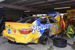 Crew members work on the crashed car of Kyle Busch, Joe Gibbs Racing Toyota