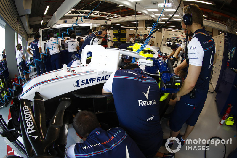 engineers work on the car of Lance Stroll, Williams FW41, in the garage
