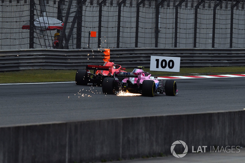 Esteban Ocon, Force India VJM11 sparks and Sebastian Vettel, Ferrari SF71H