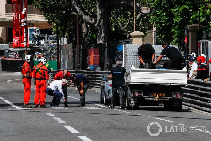Charlie Whiting, delegado de la FIA supervisa las reparaciones de una cubierta de desagüe suelta que provocó que el FP2 se marcara con una bandera roja