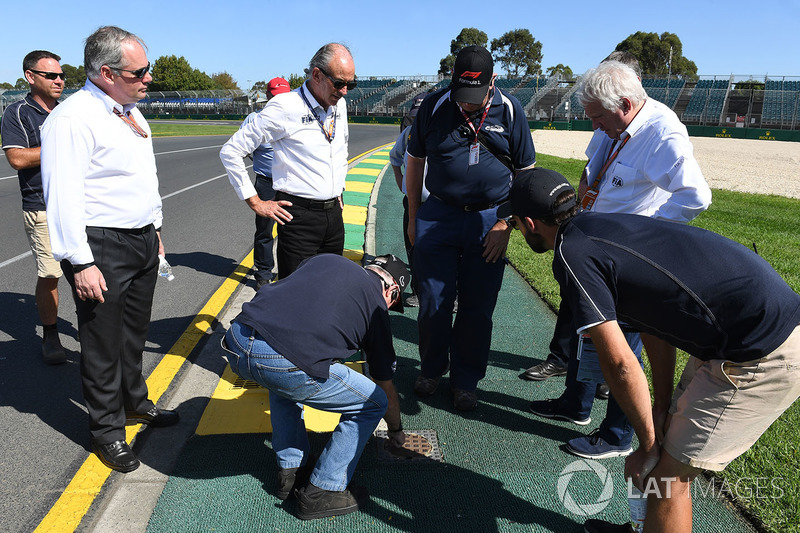 Charlie Whiting, FIA Delegate inspects the track and kerbs