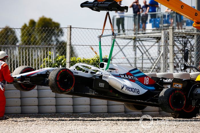Los oficiales retiran el coche de Lance Stroll, Williams FW41, de la grava