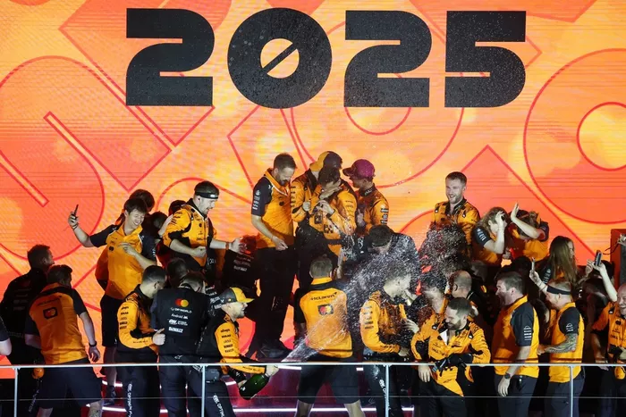 The McLaren team celebrate after securing victory in the Constructors Championship 
