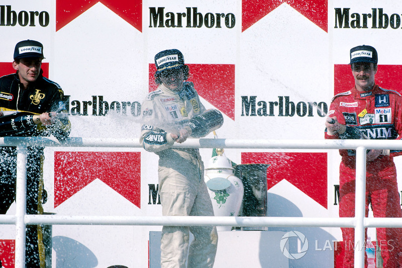 Podium: Race winner Nelson Piquet, Williams, second place Ayrton Senna, Lotus, third place Nigel Man