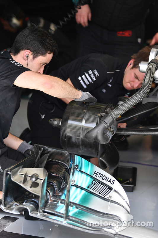 Mercedes AMG F1 mechanics work on Mercedes-Benz F1 W08 Hybrid front wheel hub