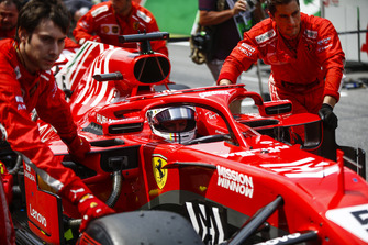 Sebastian Vettel, Ferrari, is pushed onto the grid.