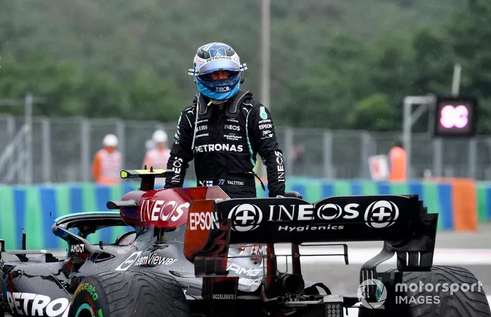 Valtteri Bottas, Mercedes, walks away from his damaged car after crashing out at the start