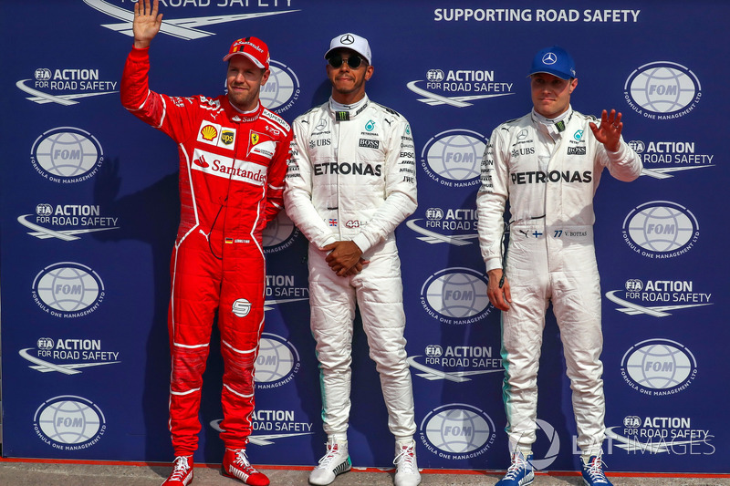 Polesitter Lewis Hamilton, Mercedes AMG F1 celebrates in parc ferme alongside Sebastian Vettel, Ferr