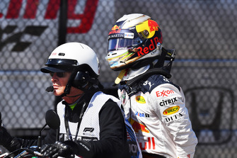 Daniel Ricciardo, Red Bull Racing on the back of a motorbike after retiring