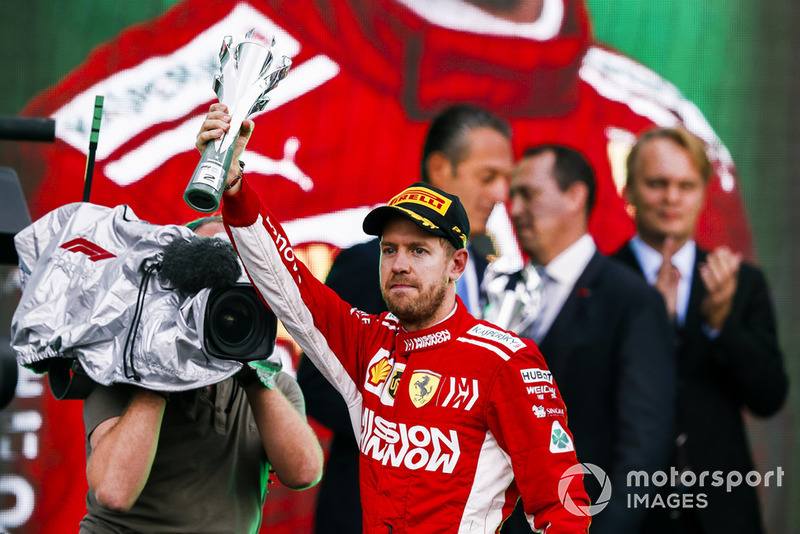 Sebastian Vettel, Ferrari, 2nd position, lifts his trophy on the podium