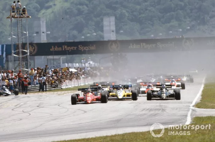Michele Alboreto, Ferrari 126C4, leads Nigel Mansell, Lotus 95T Renault, and Derek Warwick, Renault RE50, at the start