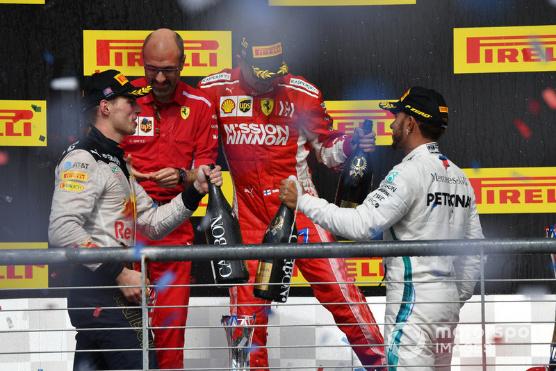 (L to R): Max Verstappen, Red Bull Racing, Carlo Santi, Ferrari Race Engineer, Race Winner Kimi Raikkonen, Ferrari and Lewis Hamilton, Mercedes AMG F1 celebrate on the podium with the champagne