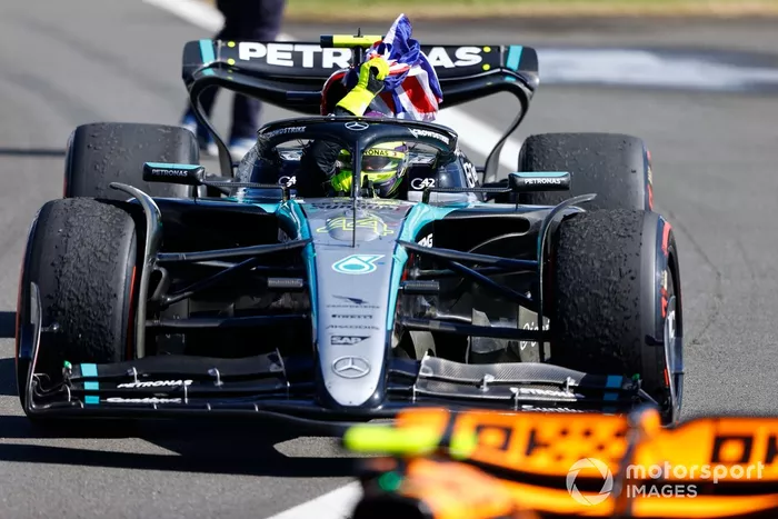 Lewis Hamilton, Mercedes F1 W15, 1ª posición, conduce hasta Parc Ferme mientras ondea una bandera de la Unión desde su cabina.
