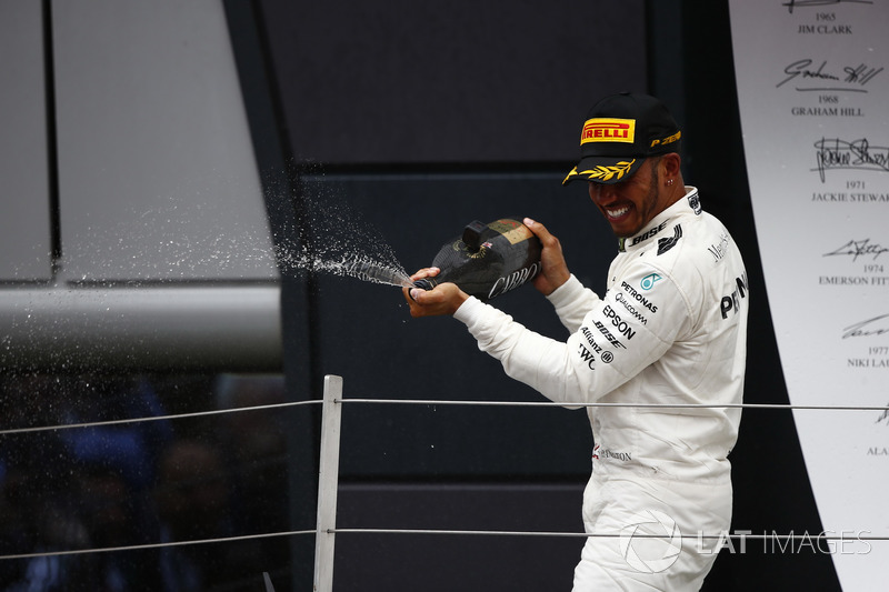 Race winner Lewis Hamilton, Mercedes AMG F1, celebrates with champagne on the podium
