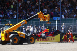 Marshals remove the wrecked Max Verstappen Red Bull Racing RB14