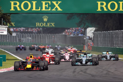 Max Verstappen, Red Bull Racing RB13 leads at the start of the race with Lewis Hamilton, Mercedes-Benz F1 W08 and rear puncture after colliding with Sebastian Vettel, Ferrari SF70H