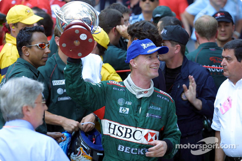 Eddie Irvine celebrating his 3rd place