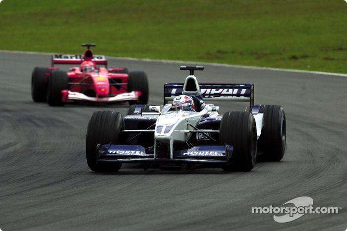 Juan Pablo Montoya in front of Michael Schumacher