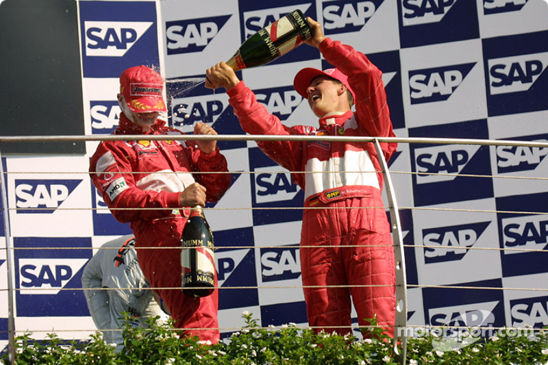 The podium: champagne for race winner Rubens Barrichello and Michael Schumacher