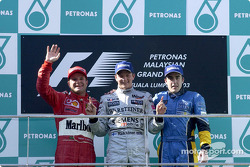 Kimi Raikkonen com Rubens Barrichello e Fernando Alonso