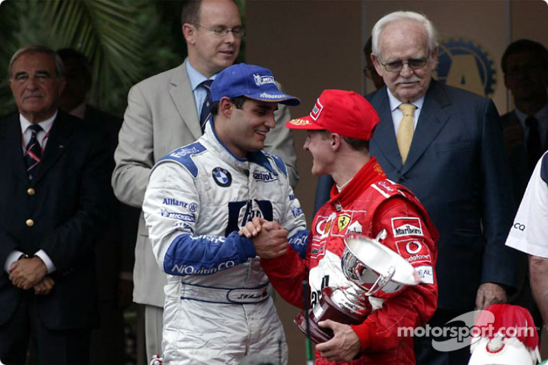 The podium: race winner Juan Pablo Montoya with Michael Schumacher