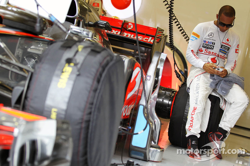 Lewis Hamilton, McLaren on his mobile phone in the pits