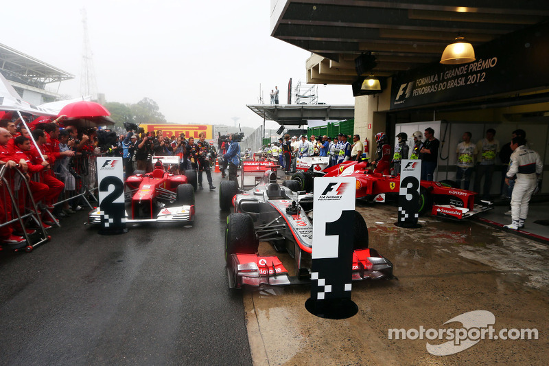 The cars in parc ferme, Fernando Alonso, Ferrari, second; Jenson Button, McLaren, race winner; Felip