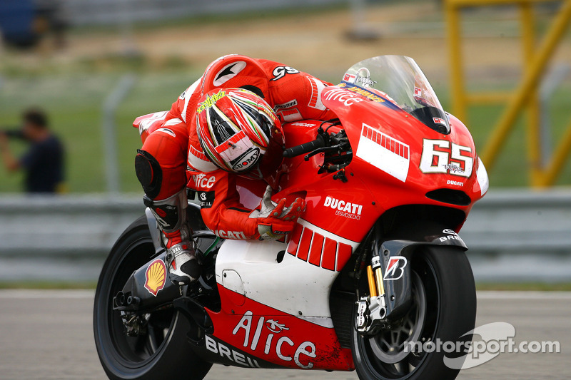 Race winner Loris Capirossi celebrates