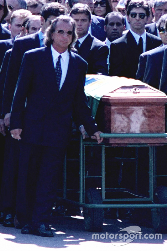 Emerson Fittipaldi, Jackie Stewart, Johnny Herbert, Derek Warwick and Damon Hill help lead the casket of Ayrton Senna during the funeral procession