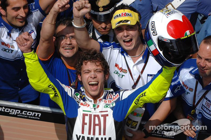 Race winner Valentino Rossi takes the checkered flag